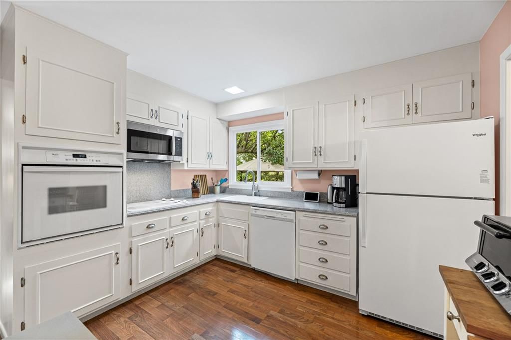 White kitchen, double oven and white appliances at 6527 Maple Drive, Mission, KS 66202