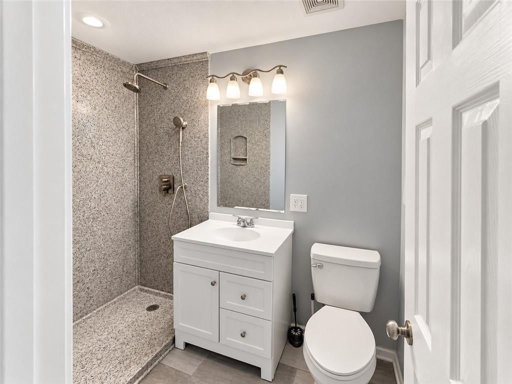 Walk-in shower and renovated bathrooms at 7516 Sni A Bar Road, Kansas City, MO 64129