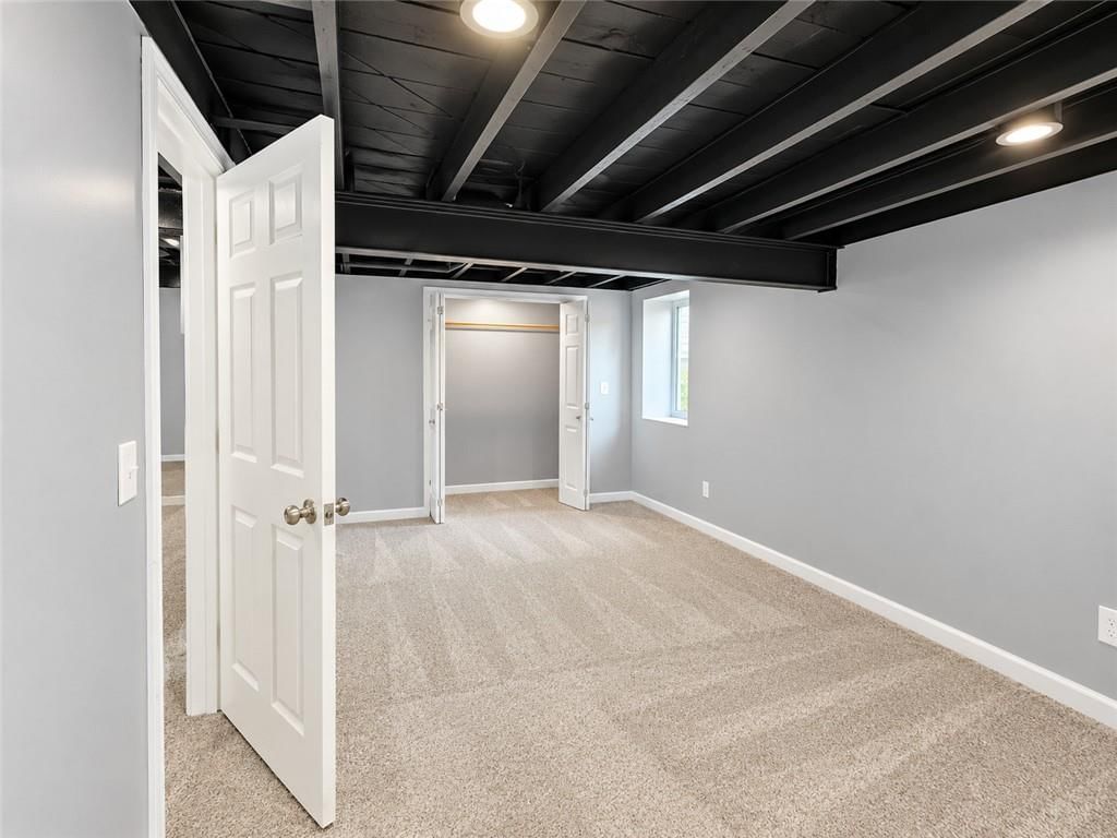 Finished basement, recessed lighting and staircase at 7516 Sni A Bar Road, Kansas City, MO 64129