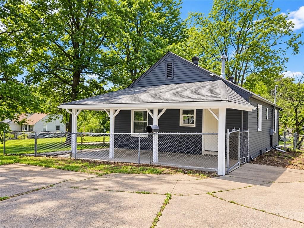 Fenced yard, covered patio and concrete driveway at 7516 Sni A Bar Road, Kansas City, MO 64129
