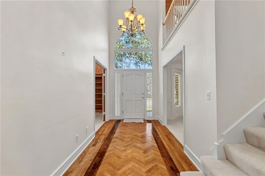 Staircase, wood stair railing and white trim at 12808 Sherwood Drive, Leawood, KS 66209