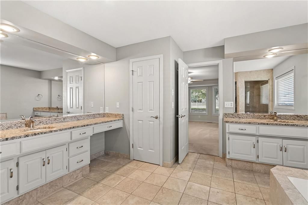 Walk-in shower, tiled shower and double vanity at 12808 Sherwood Drive, Leawood, KS 66209