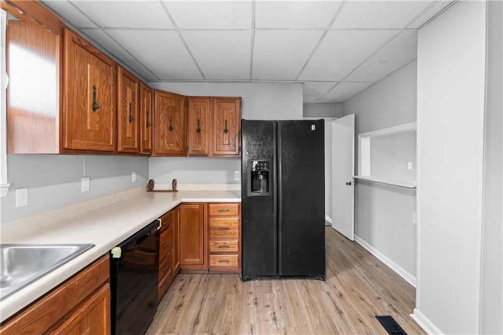 Wood kitchen cabinets, electric range and black appliances at 222 N 17th Street, Kansas City, KS 66102