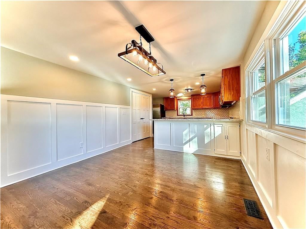 Kitchen island, granite counters and wainscoting or board and batten at 4833 N Winchester Street, Kansas City, MO 64119
