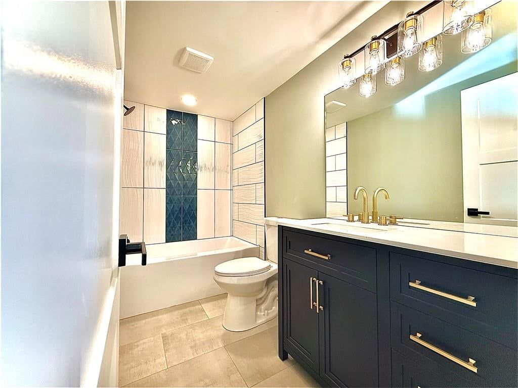 Tile floors and renovated bathrooms at 4833 N Winchester Street, Kansas City, MO 64119