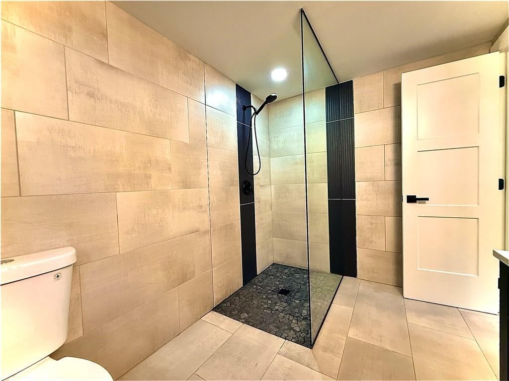 Walk-in shower, tiled shower and frameless glass shower at 4833 N Winchester Street, Kansas City, MO 64119