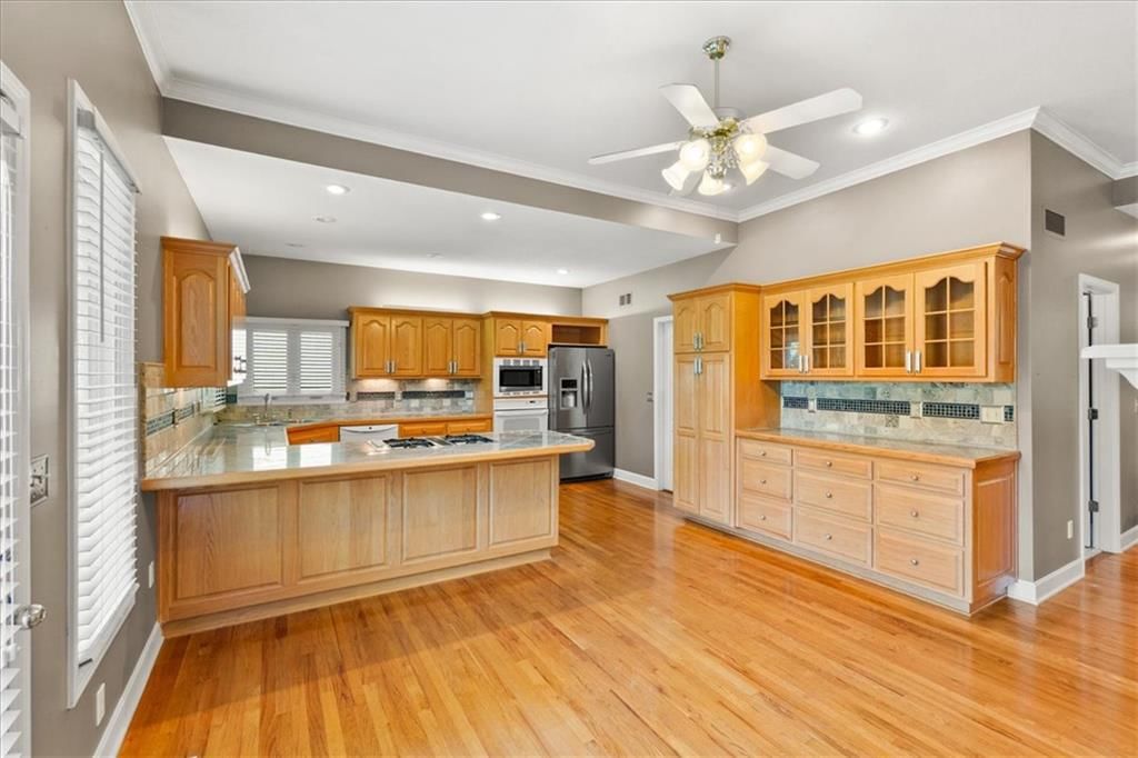 Kitchen island, gas range and double oven at 3730 S Milton Drive, Independence, MO 64055
