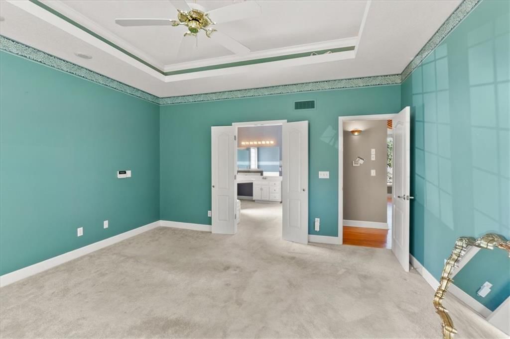 Main-floor primary bedroom and carpet at 3730 S Milton Drive, Independence, MO 64055