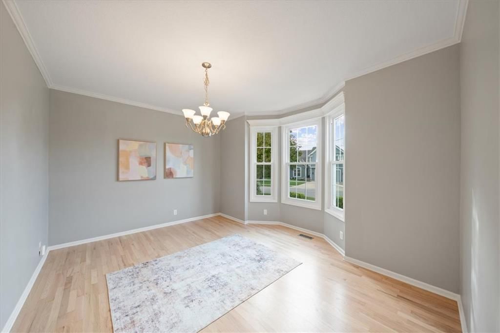 Hardwood floors, statement lighting and white trim at 10138 Theden Circle, Lenexa, KS 66220
