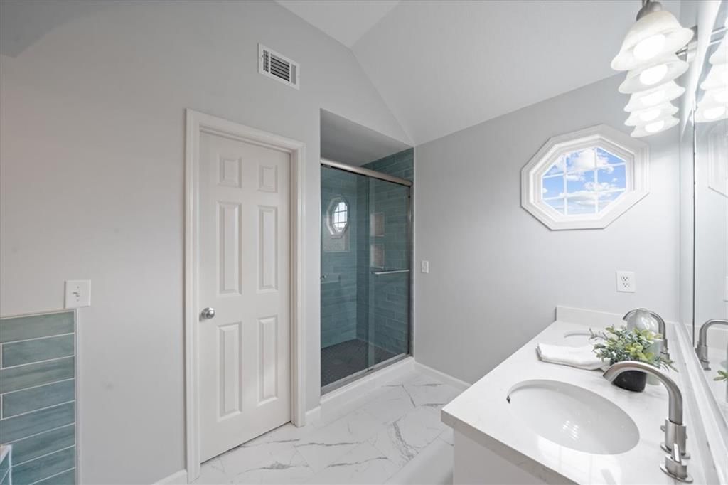 Walk-in shower and tiled shower at 10138 Theden Circle, Lenexa, KS 66220