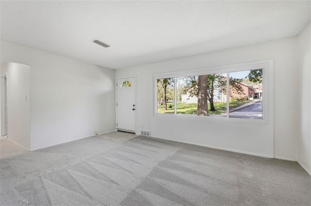 Main-floor primary bedroom, black hardware and white trim at 11235 Bristol Terrace, Kansas City, MO 64134