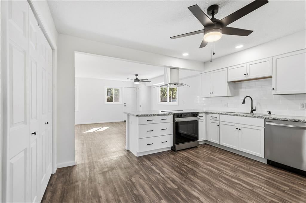 Open floor plan, kitchen island and white kitchen at 11235 Bristol Terrace, Kansas City, MO 64134