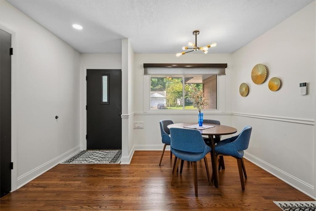 Hardwood floors, statement lighting and white trim at 8601 Belleview Avenue, Kansas City, MO 64114