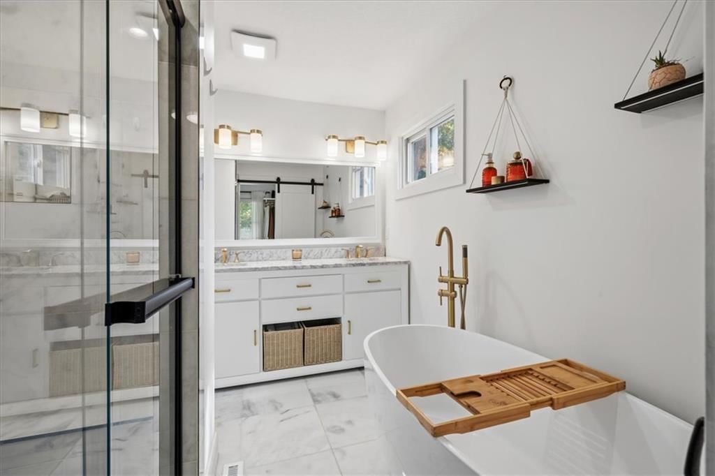 Freestanding tub and renovated bathrooms at 8601 Belleview Avenue, Kansas City, MO 64114