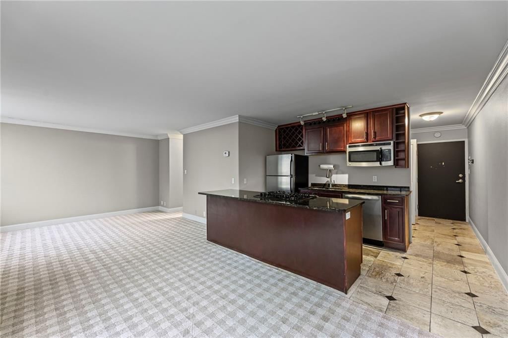 Open floor plan, kitchen island and tile floors at 700 E 8th Street #6E, Kansas City, MO 64106