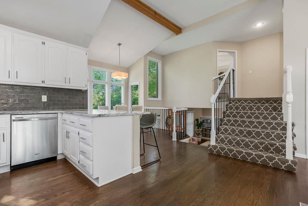 Open floor plan, kitchen island and hardwood floors at 4732 Chouteau Street, Shawnee, KS 66226