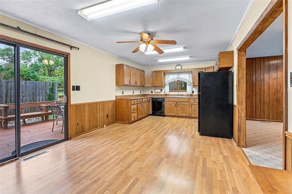 Breakfast nook, wood kitchen cabinets and black appliances at 6920 W 72nd Terrace, Overland Park, KS 66204