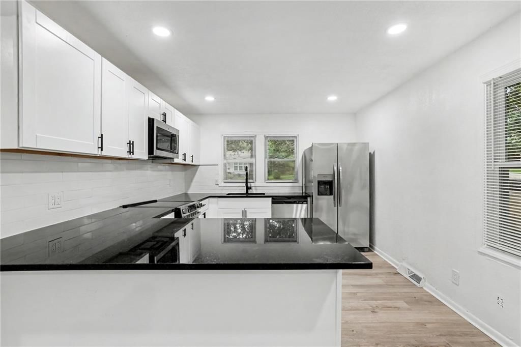 White kitchen, quartz counters and shaker cabinets at 13512 W 90th Place, Lenexa, KS 66215
