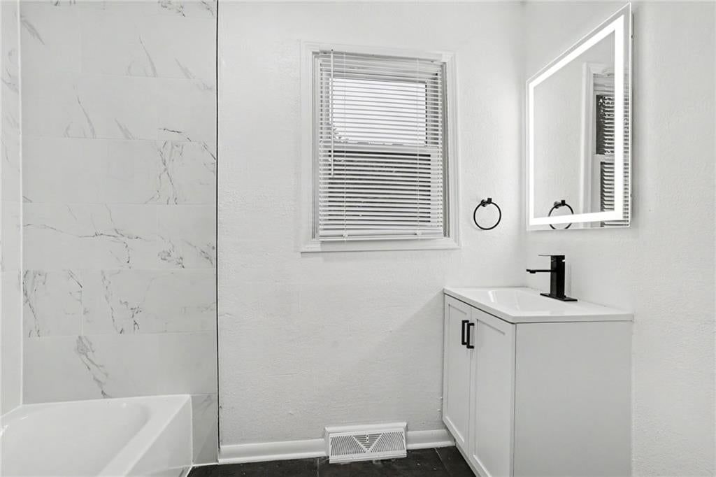 White vanity and renovated bathrooms at 13512 W 90th Place, Lenexa, KS 66215