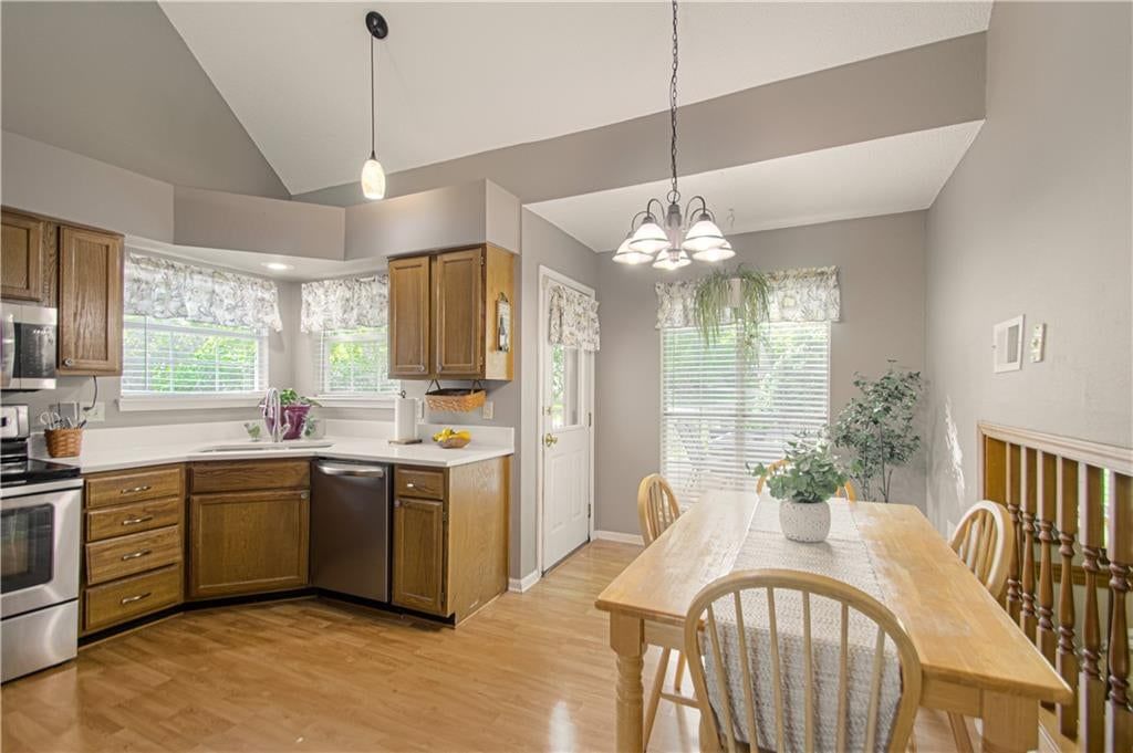 Stainless steel appliances, breakfast nook and wood kitchen cabinets at 1133 E Charlotte Town Road, Olathe, KS 66061