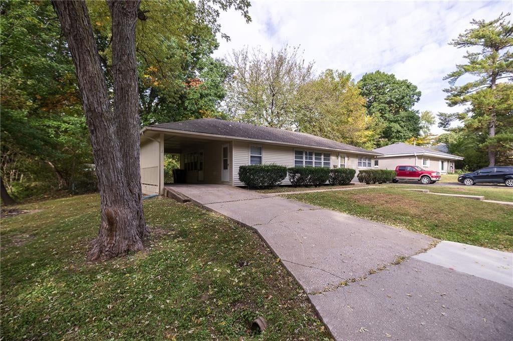Covered front porch and concrete driveway at 5444 N Cypress Avenue, Kansas City, MO 64119