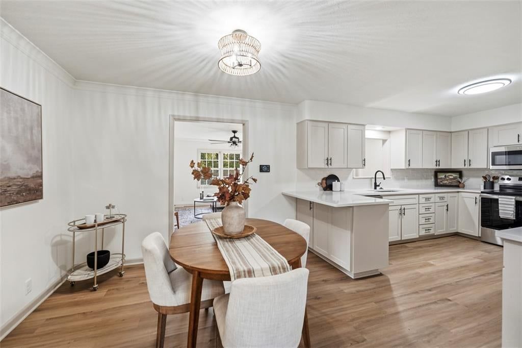 Statement lighting and breakfast nook at 5416 NE Circle Drive, Kansas City, MO 64119