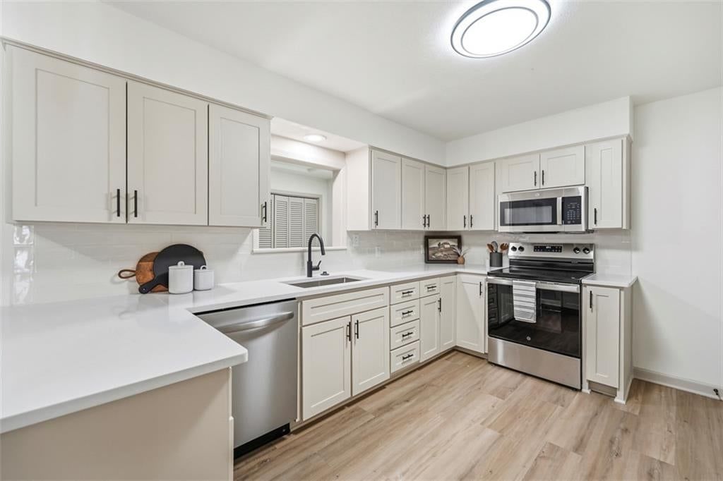 Electric range and recessed lighting at 5416 NE Circle Drive, Kansas City, MO 64119