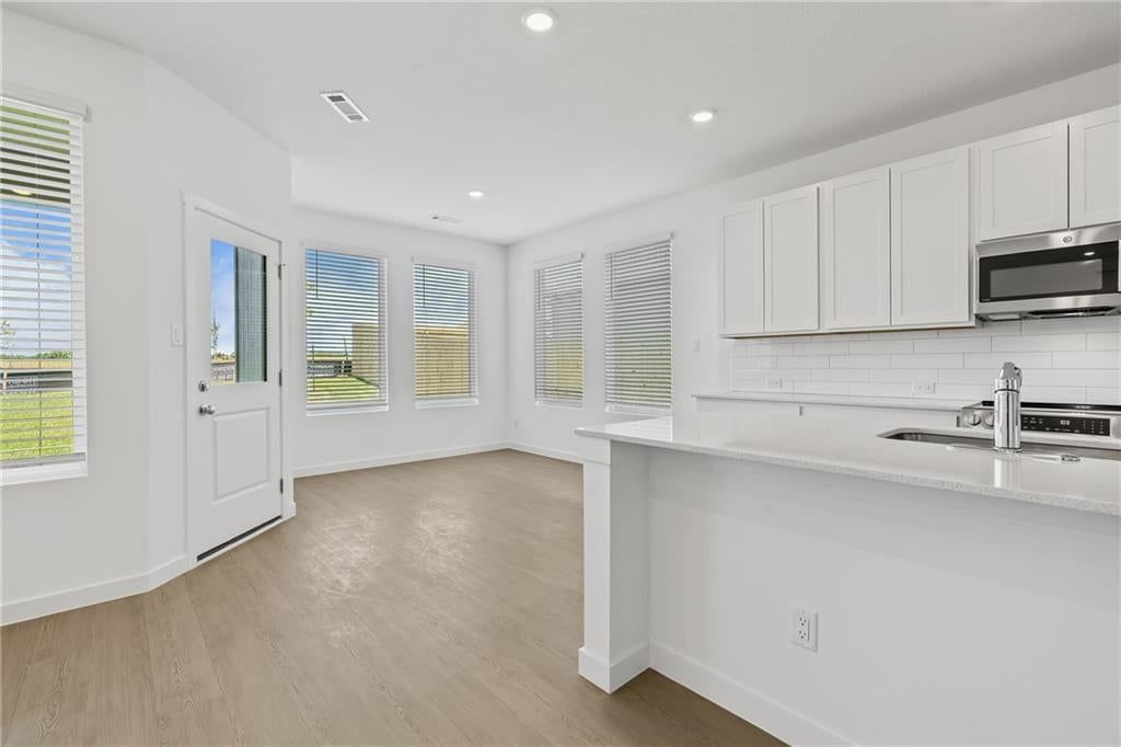 Wall of windows and breakfast nook at 21359 Cleveland Street, Spring Hill, KS 66083