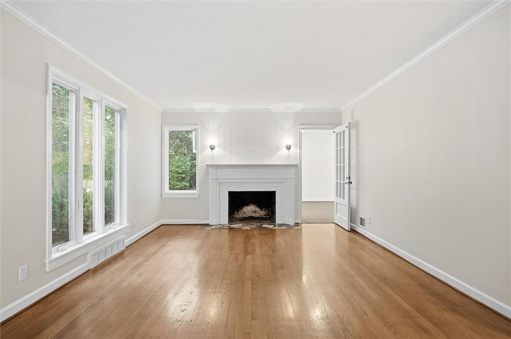 Fireplace, hardwood floors and wall of windows at 4124 Brookridge Drive, Fairway, KS 66205