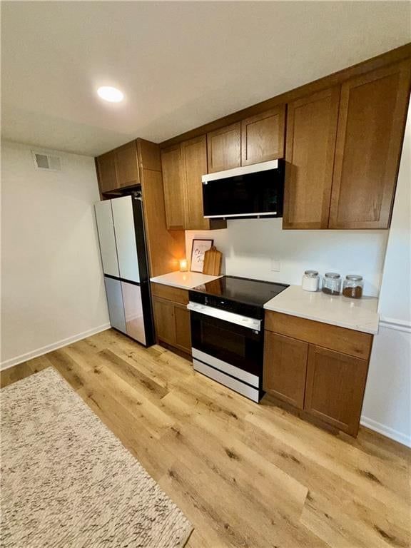Electric range and mixed-finish appliances at 12100 59 Street, Kansas City, MO 64133