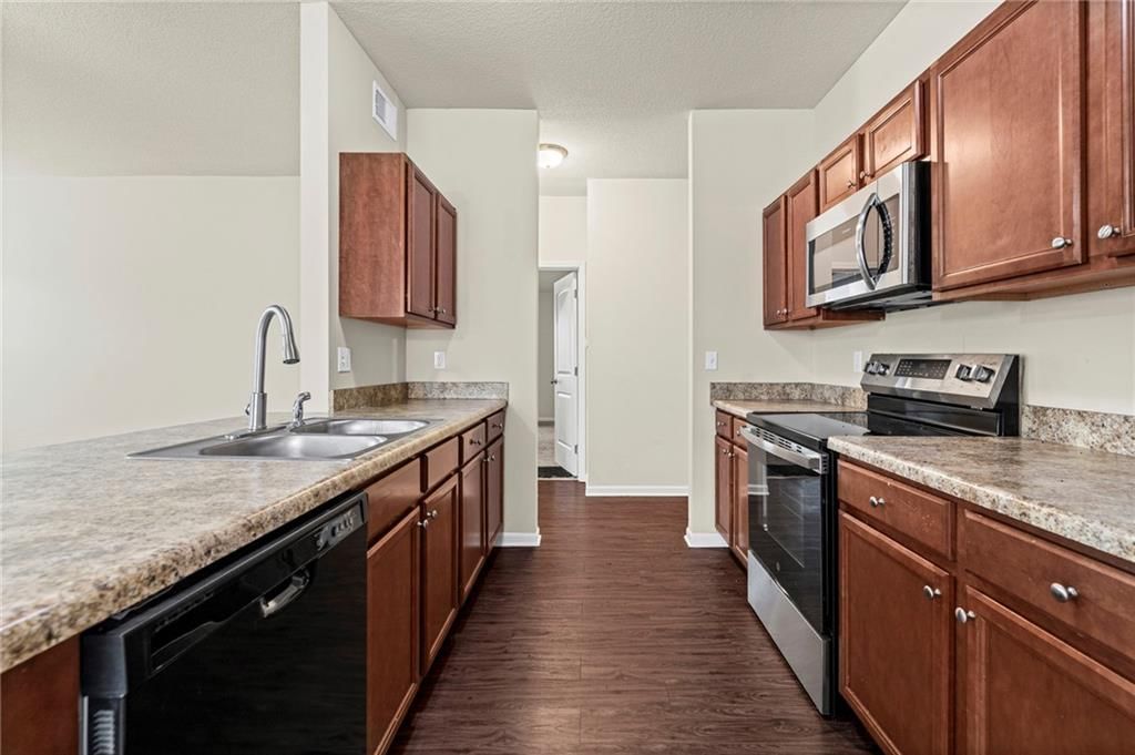 Electric range and beige or brown countertops at 31863 W 172nd Street, Gardner, KS 66030