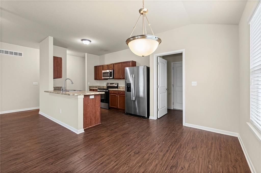 Kitchen island, stainless steel appliances and breakfast nook at 31863 W 172nd Street, Gardner, KS 66030