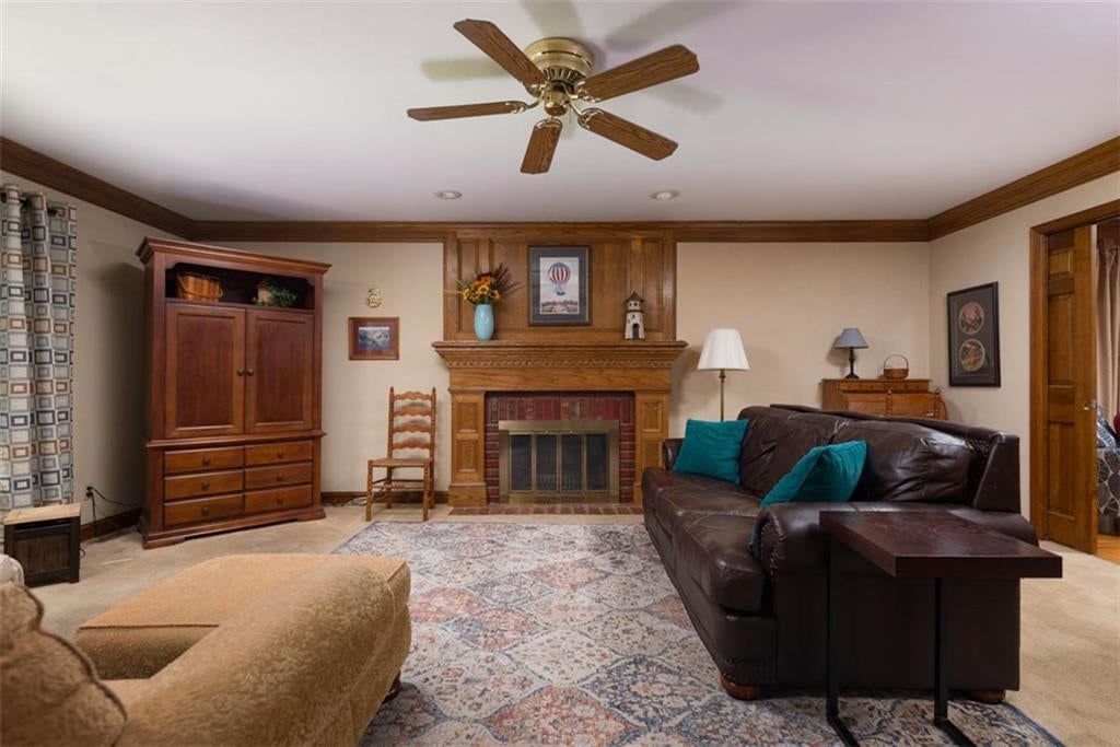 Fireplace, brick fireplace and beige walls at 719 White Oak Lane, Gladstone, MO 64116
