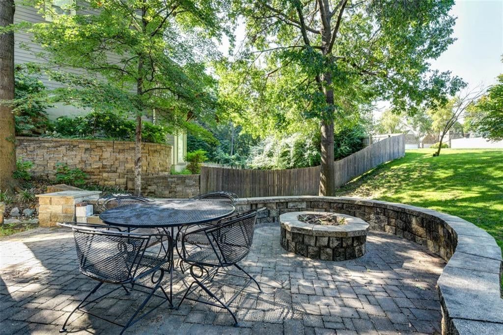 Fenced yard, fire pit and paver patio at 719 White Oak Lane, Gladstone, MO 64116