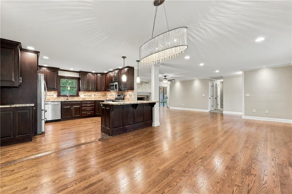 Open floor plan, statement lighting and wainscoting or board and batten at 1703 NE 77 Street, Gladstone, MO 64118