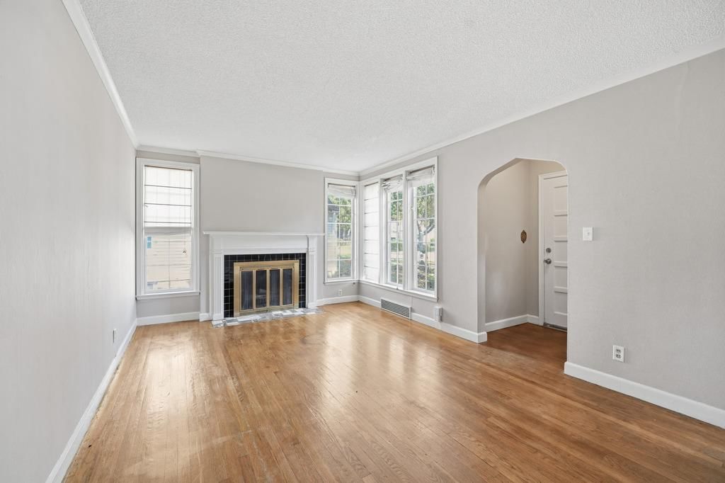 Fireplace, hardwood floors and white trim at 4920 Birch Street, Roeland Park, KS 66205