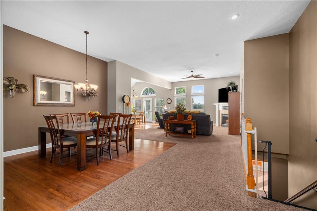 Hardwood floors, staircase and wood stair railing at 207 Peach Tree Avenue, Lone Jack, MO 64070
