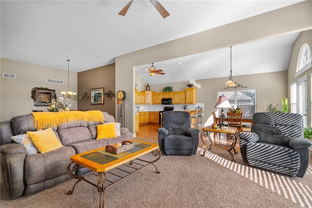 Tall ceilings, open floor plan and wall of windows at 207 Peach Tree Avenue, Lone Jack, MO 64070