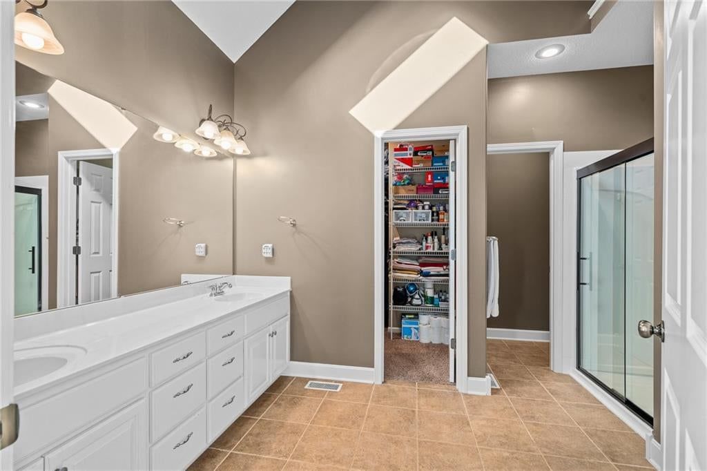 Tile floors and double vanity at 207 Peach Tree Avenue, Lone Jack, MO 64070