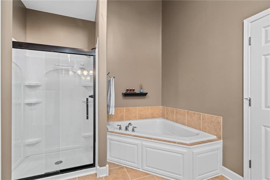 Walk-in shower and tiled shower at 207 Peach Tree Avenue, Lone Jack, MO 64070