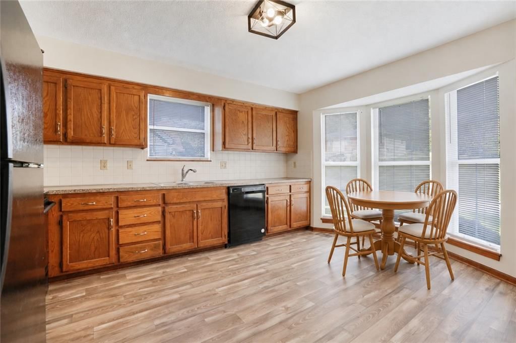 Breakfast nook, wood kitchen cabinets and kitchen backsplash at 5511 NE 50th Street, Kansas City, MO 64119