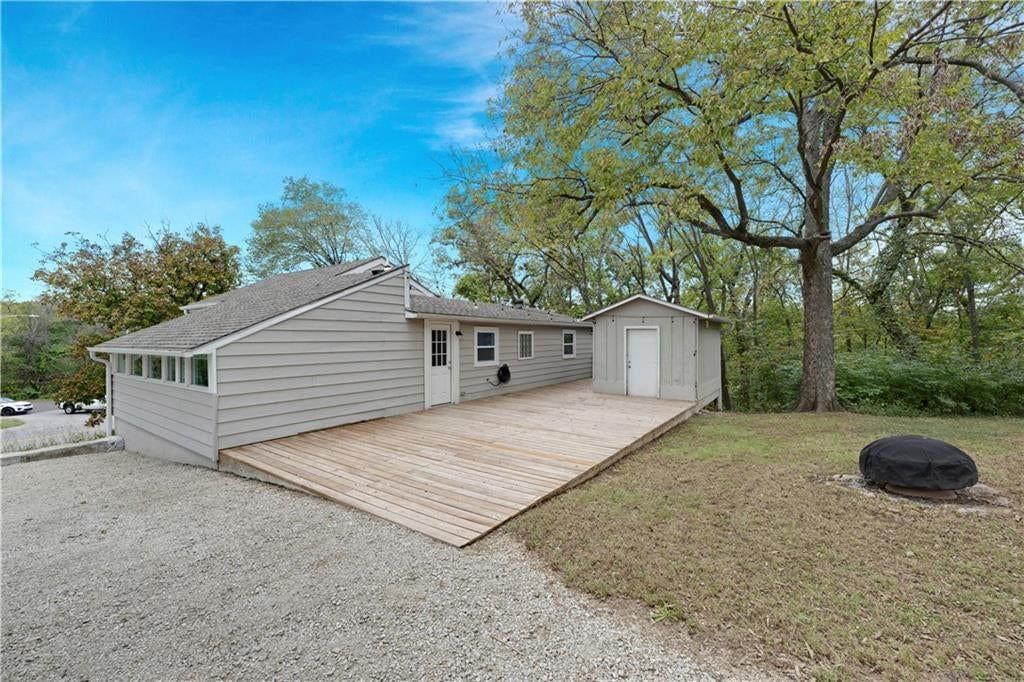 Mature trees, siding exterior and flat lot at 165 T Street, Lake Lotawana, MO 64086