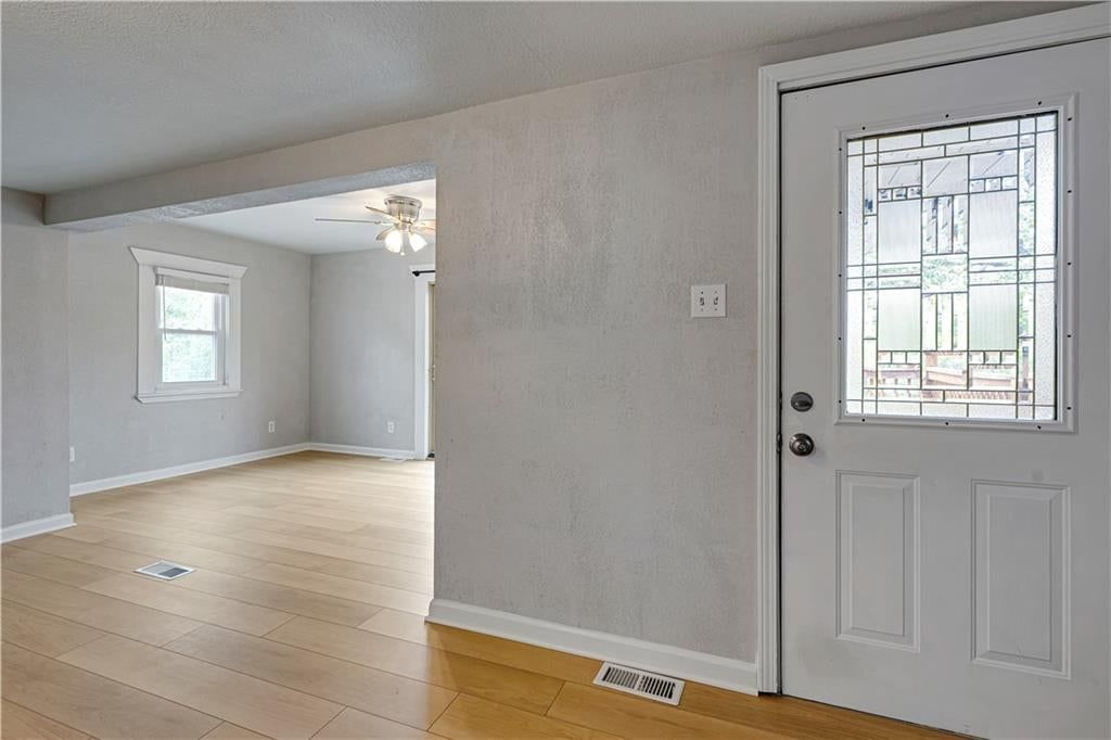 Open floor plan, hardwood floors and recessed lighting at 165 T Street, Lake Lotawana, MO 64086