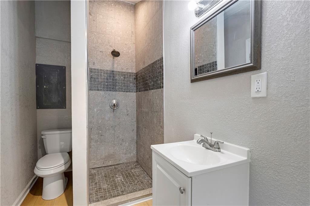Walk-in shower, private toilet room and frameless glass shower at 165 T Street, Lake Lotawana, MO 64086