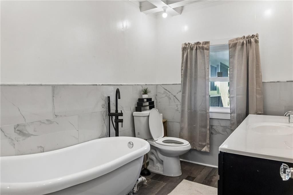 Freestanding tub and black vanity at 2955 E 29th Street, Kansas City, MO 64128