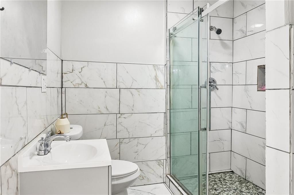 Walk-in shower, tiled shower and frameless glass shower at 2955 E 29th Street, Kansas City, MO 64128