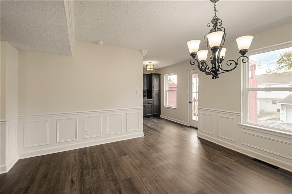Open floor plan, statement lighting and wainscoting or board and batten at 6616 E 128th Street, Grandview, MO 64030