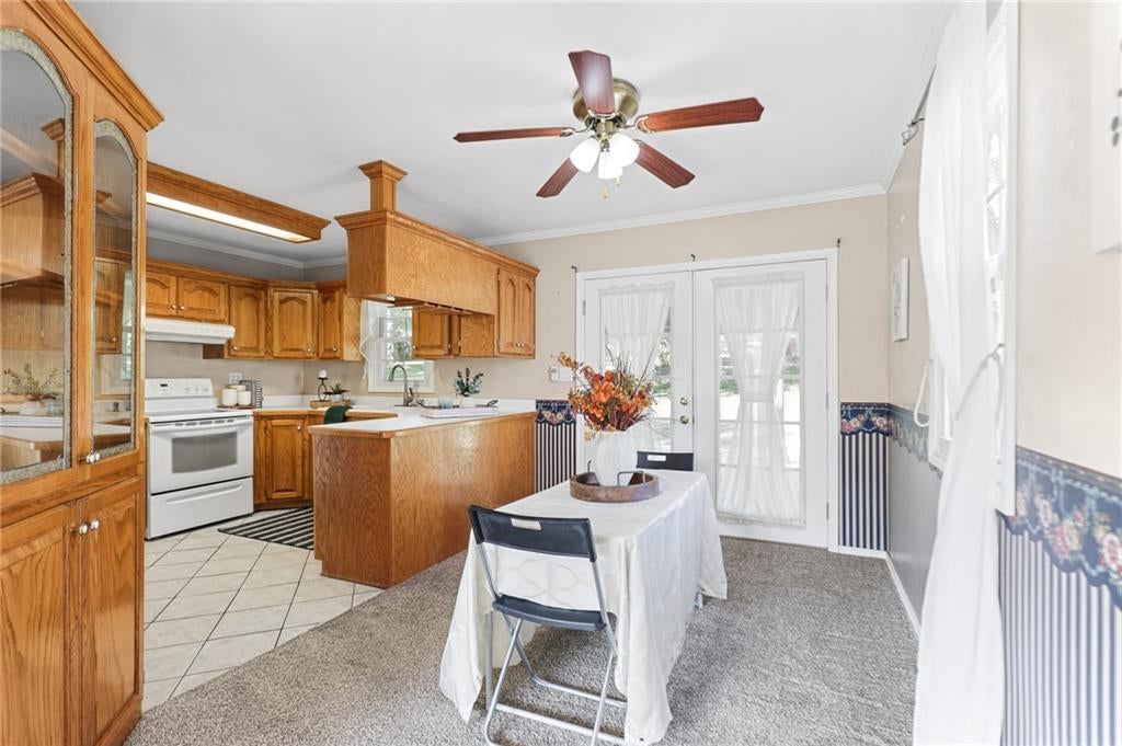 Tile floors, wood kitchen cabinets and white appliances at 3012 S Norwood Avenue S, Independence, MO 64052