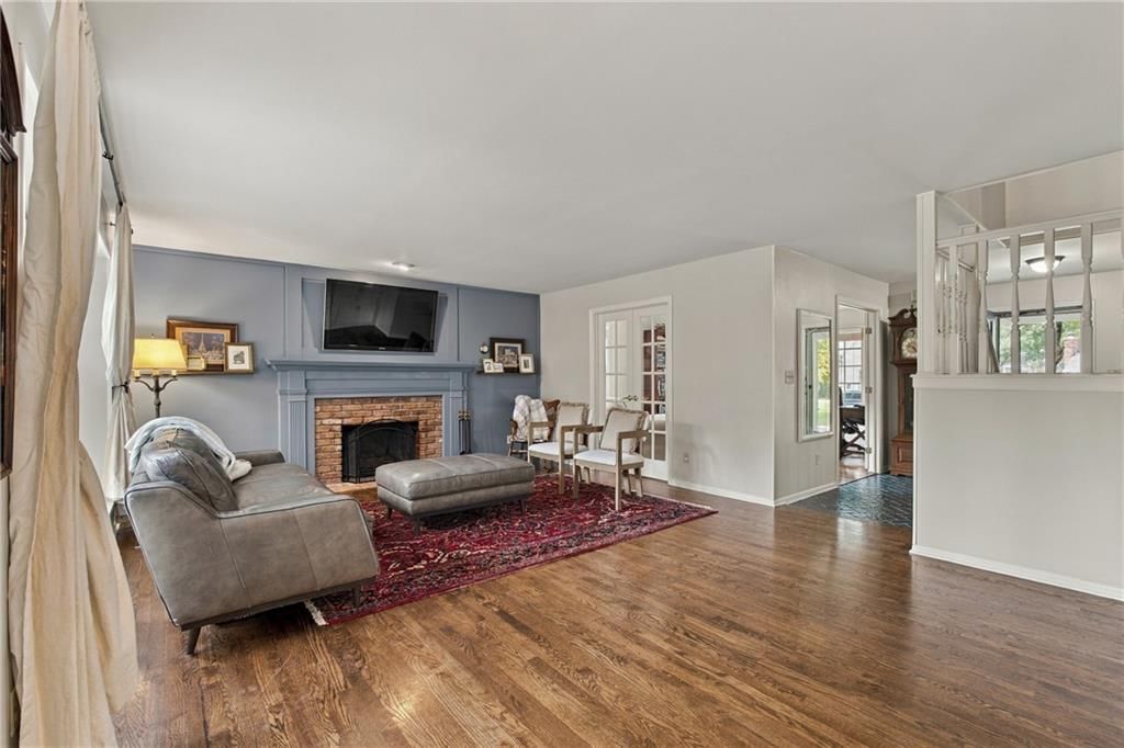 Fireplace, hardwood floors and brick fireplace at 9320 W 113th Street, Overland Park, KS 66210
