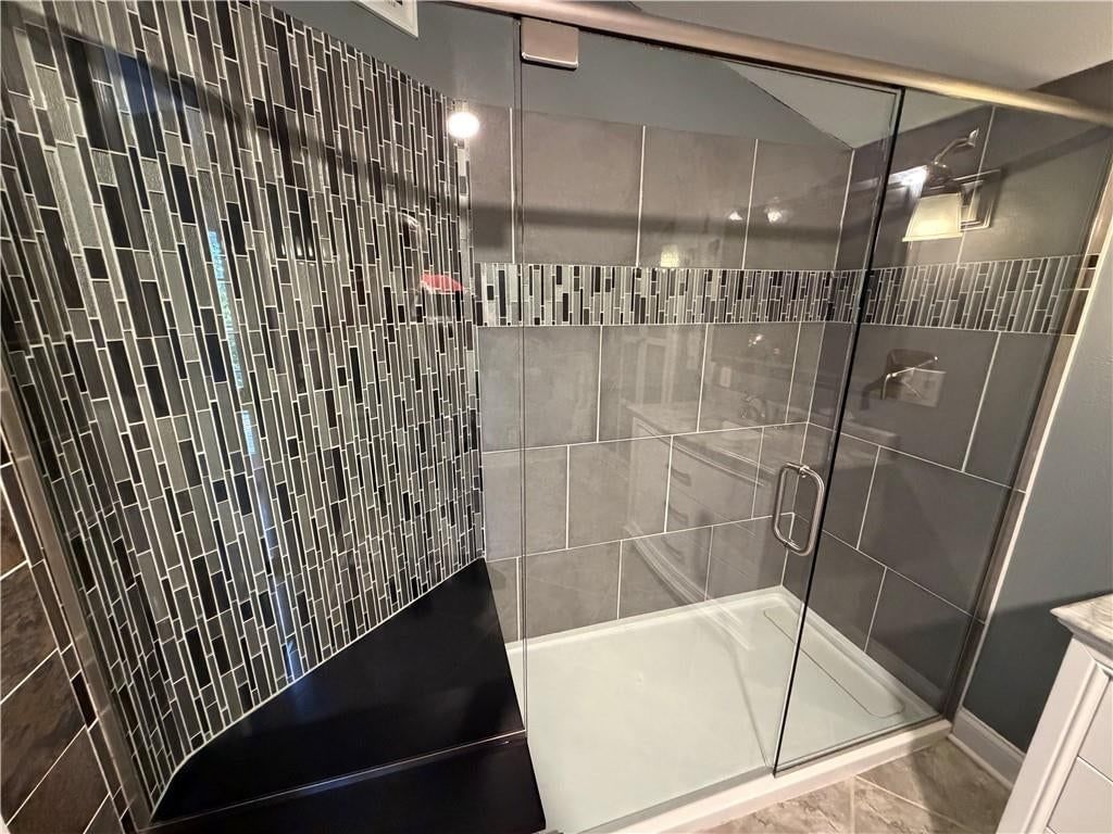 Walk-in shower, tiled shower and frameless glass shower at 209 Renee Lane, Garden City, MO 64747